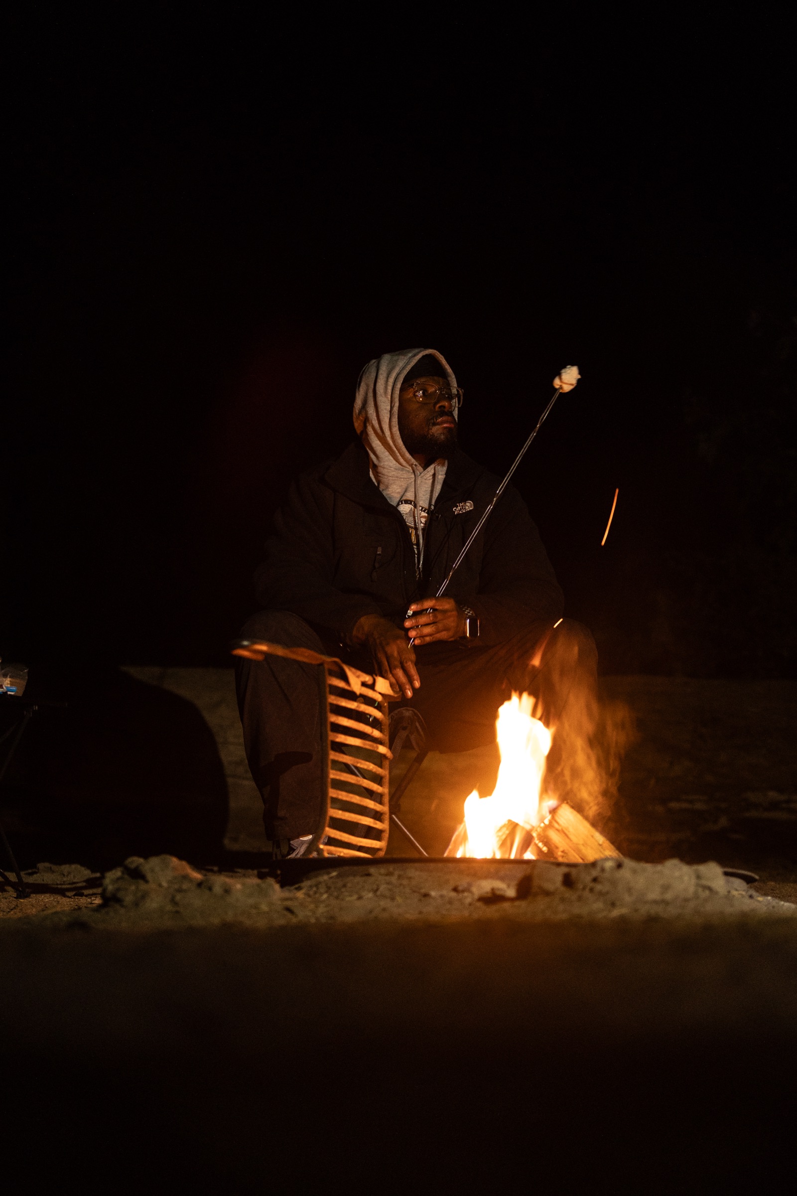Davon beside a campfire at night